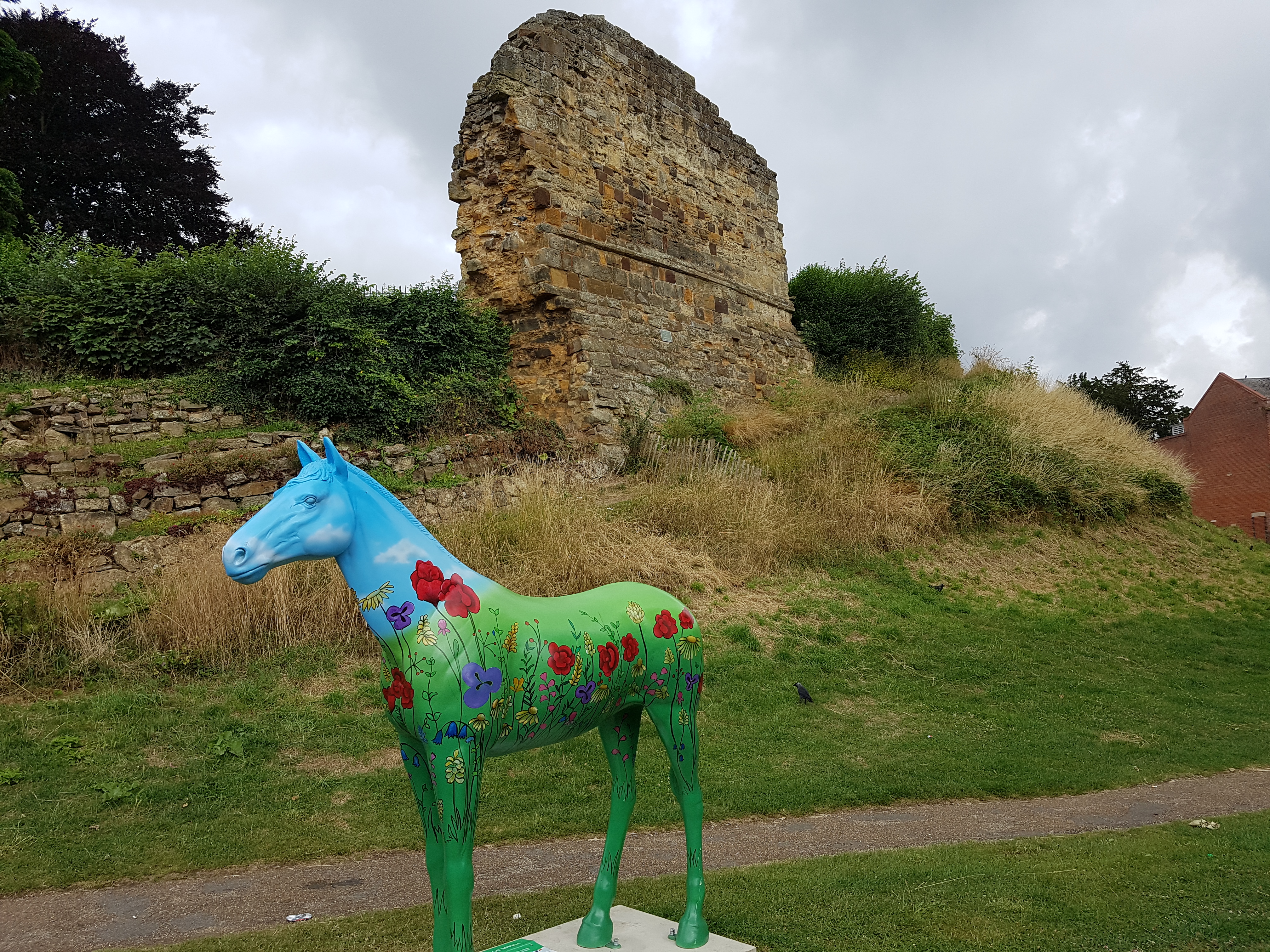 a beautiful horse sculpture in front of Tonbridge Castle